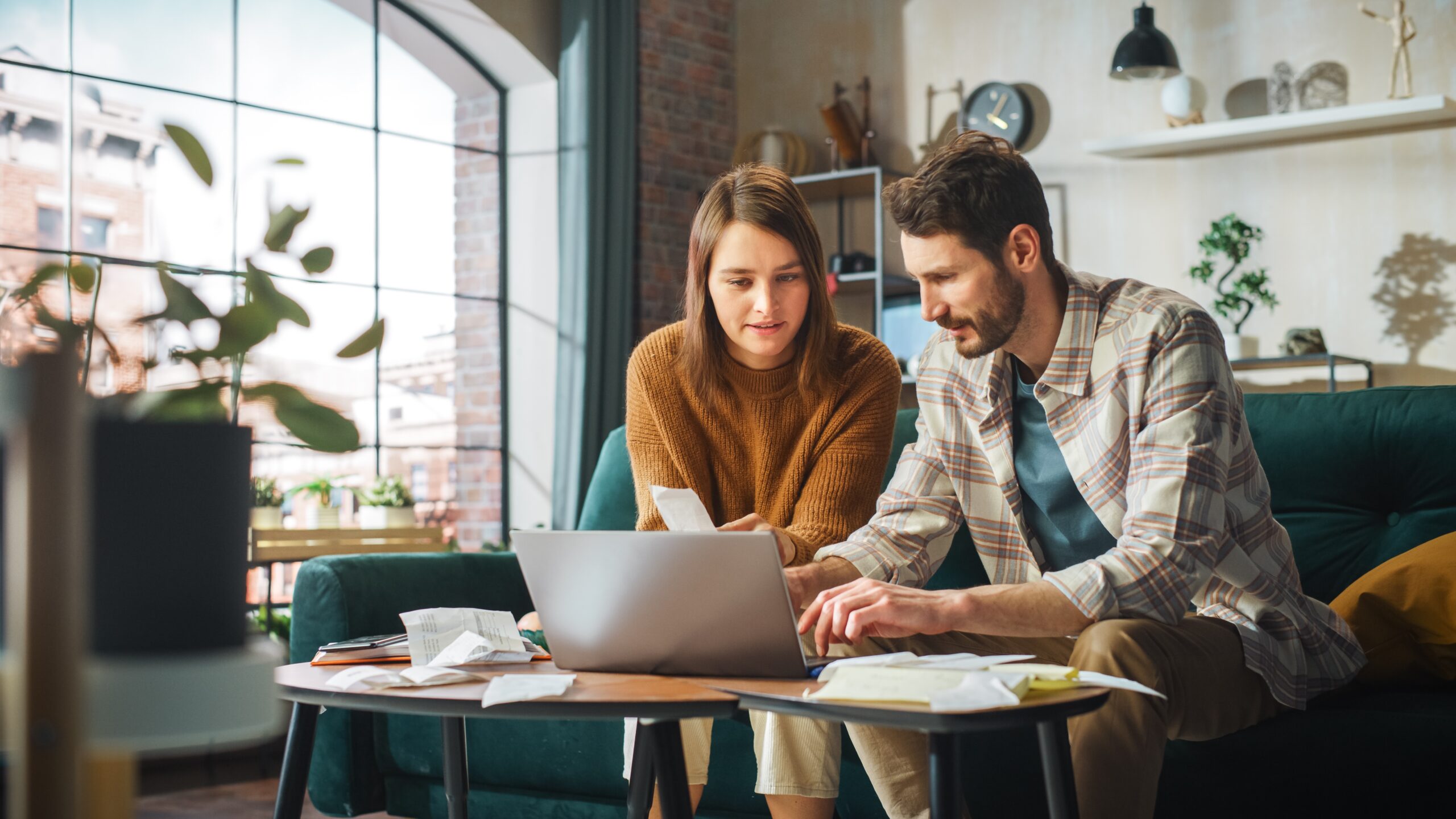 couple at home sitting on a computer