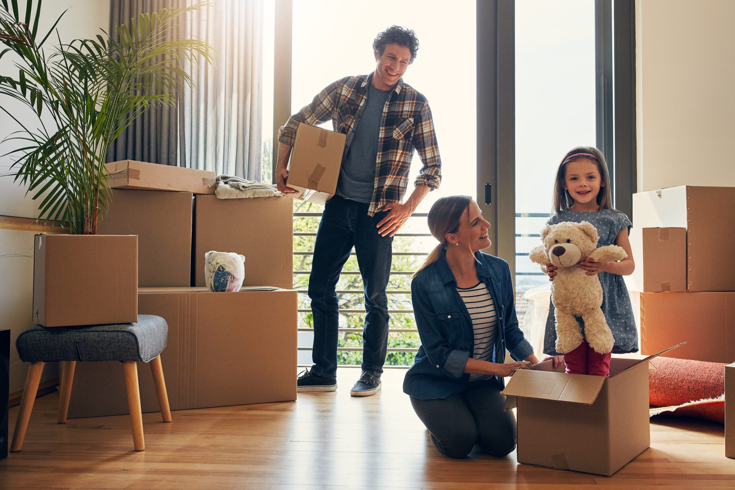 moving parents and children in portrait of a new home