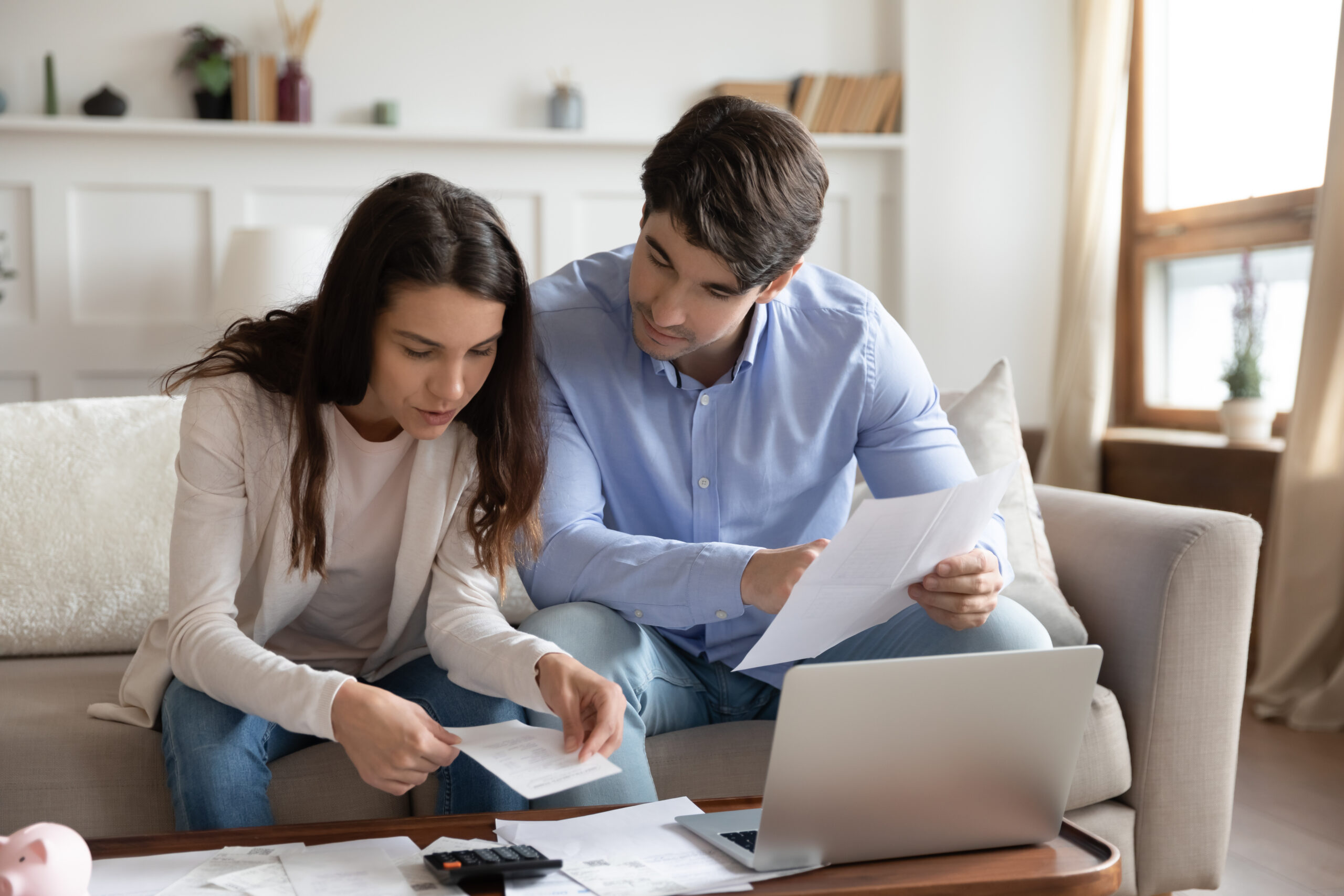close up of young couple checking mortgage