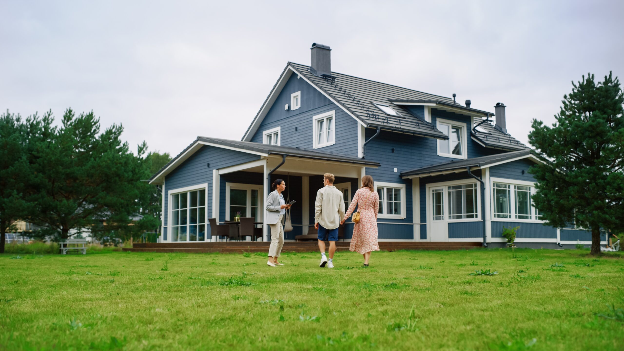 real estate agent showing a house to couple