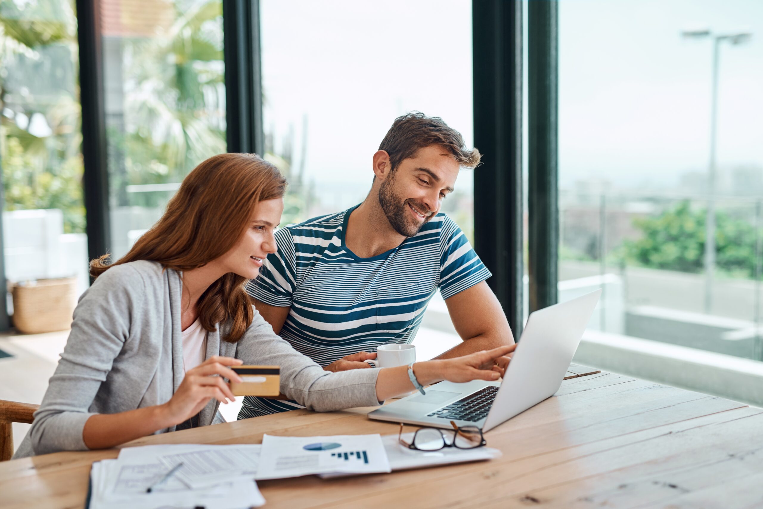 couple at home on a laptop researching