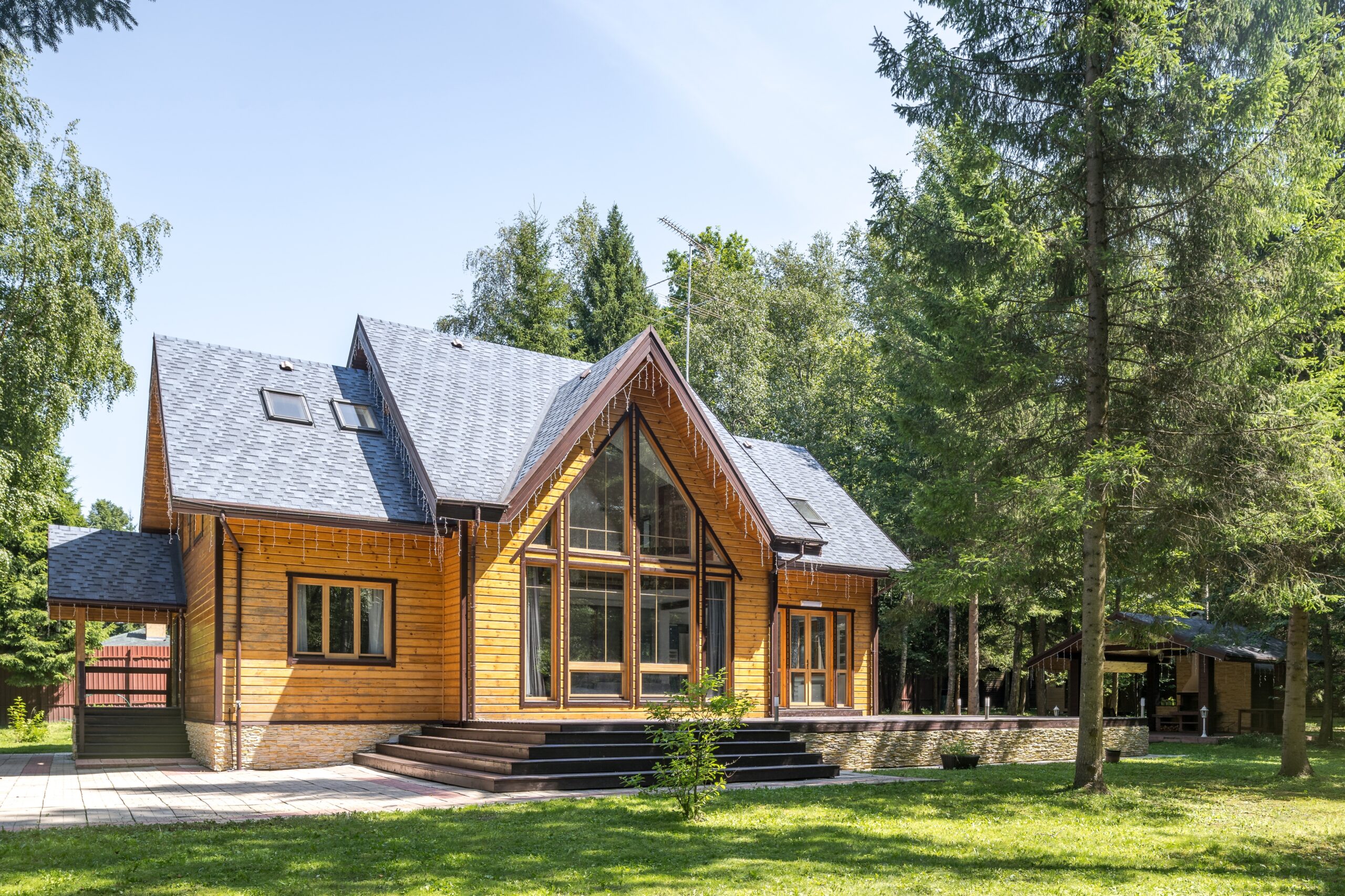 picture of home resembling a cabin surrounded by trees