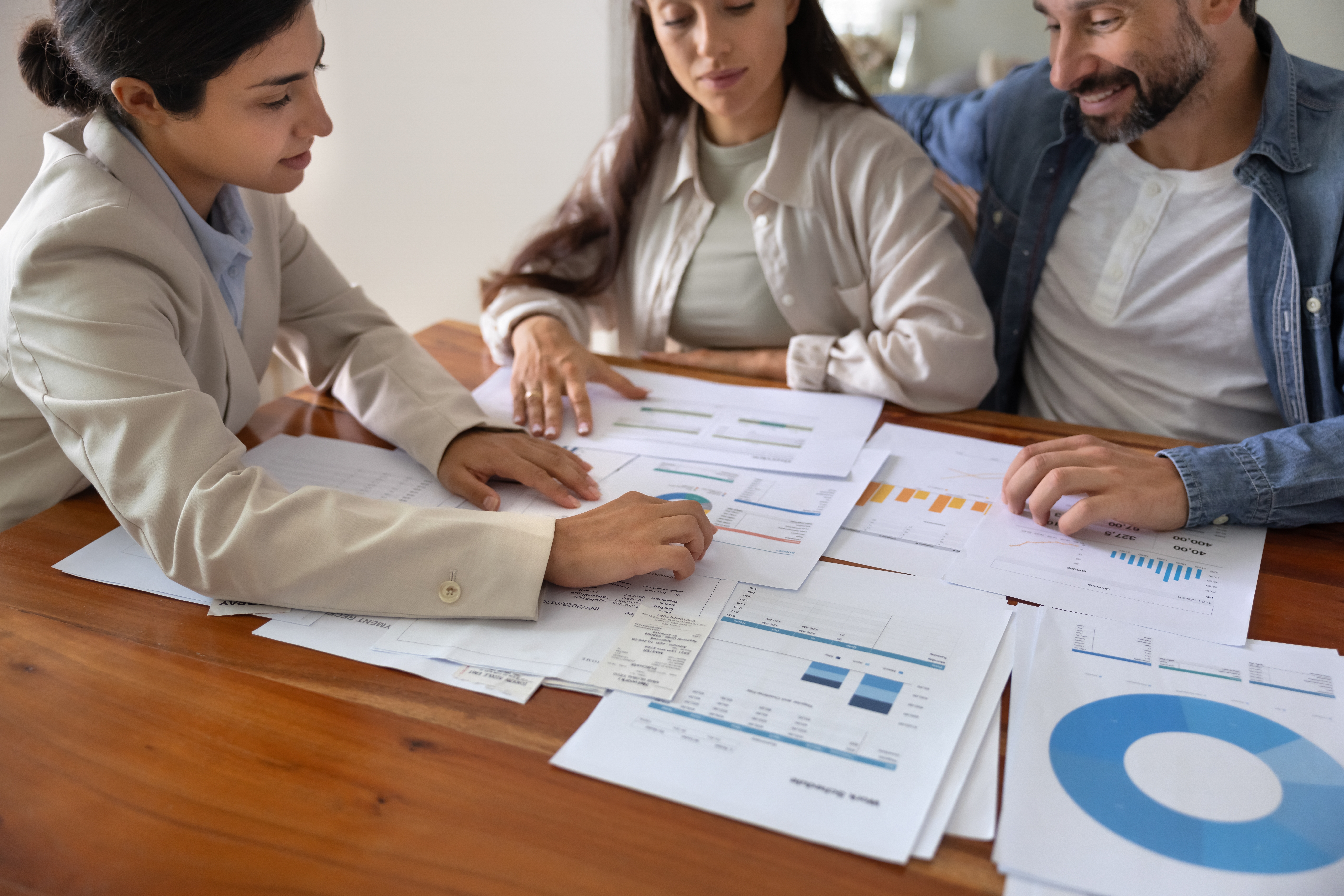 professional mortgage advisor at table with married couple