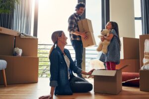 boxes and parents in new home with child