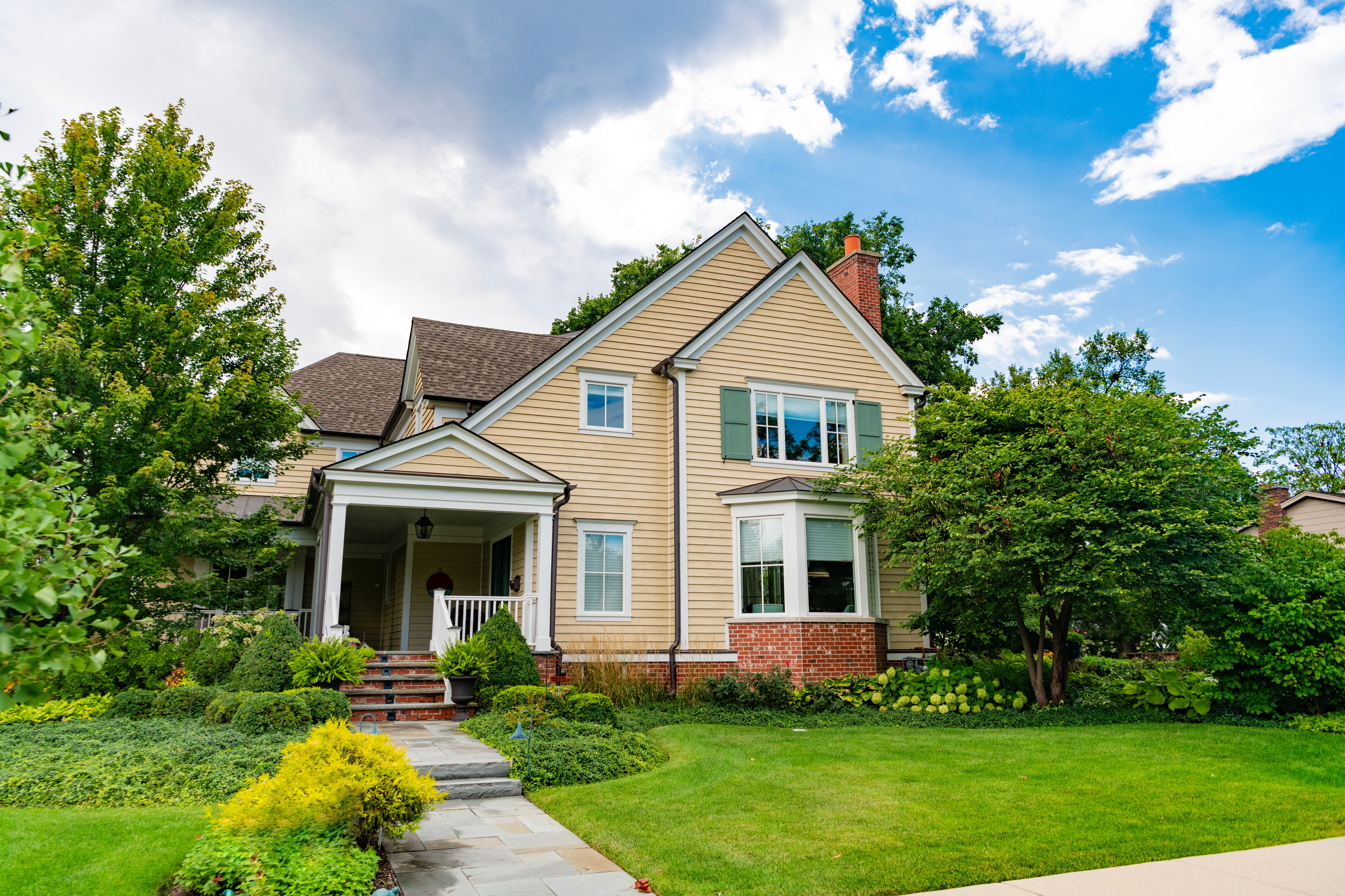 home in neighborhood with green yard and trees