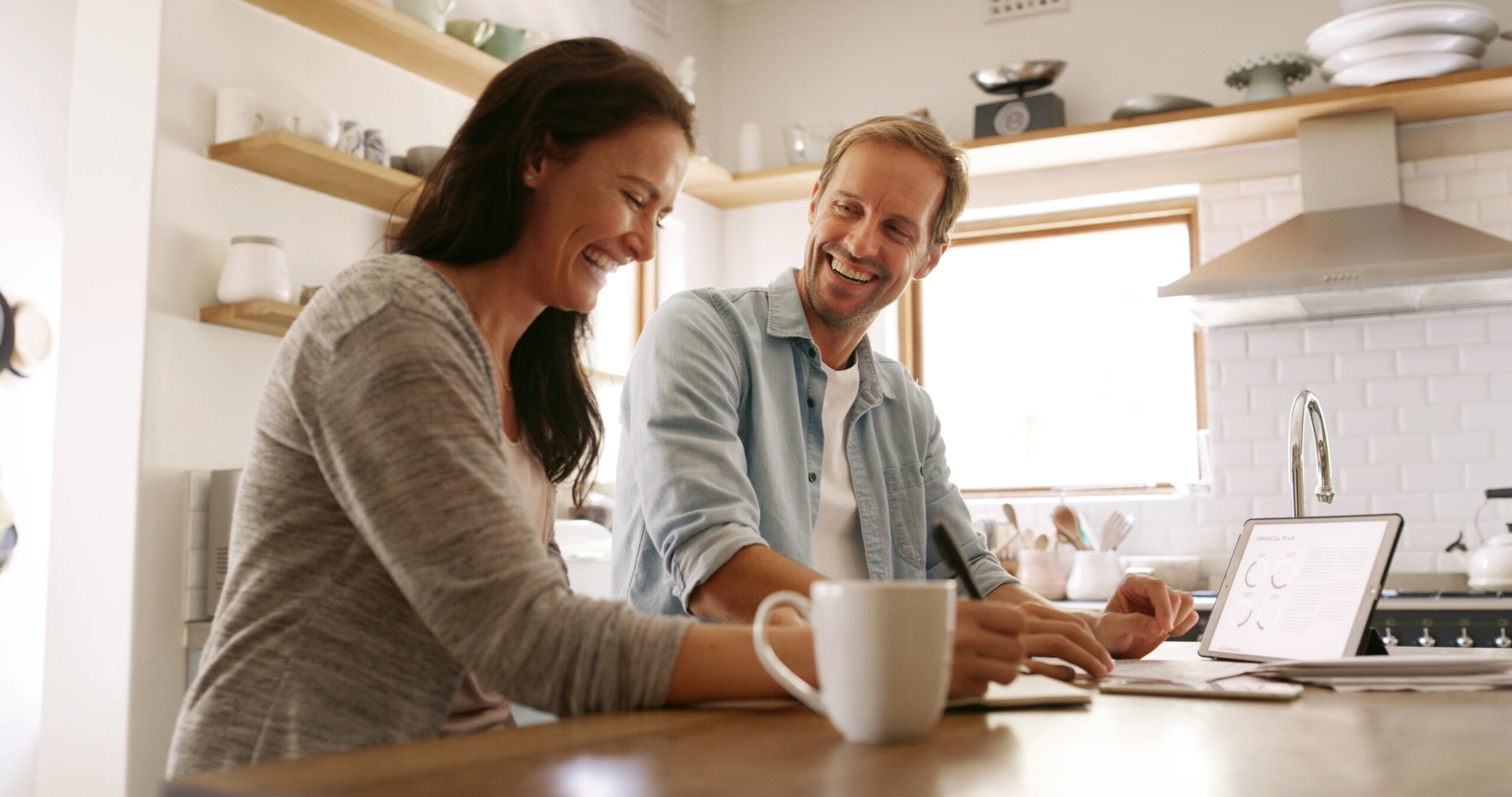 financial tablet and happy couple in home